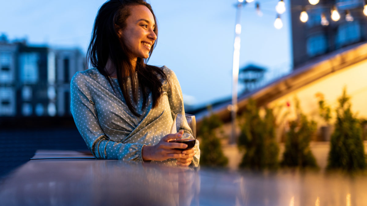 Family and friends celebrating at dinner on a rooftop terrace